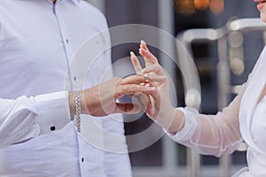 Wedding gold rings on the hands of the newlyweds. Gold rings on the hand of a man and a woman