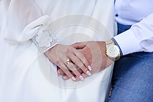 Wedding gold rings on the hands of the newlyweds. Gold rings on the hand of a man and a woman