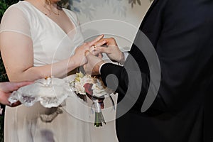 Wedding gold rings on the hands of the newlyweds. Gold rings on the hand of a man and a woman