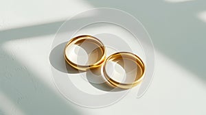Wedding gold rings on light background with shadows. Aesthetic invitation concept. Generative AI