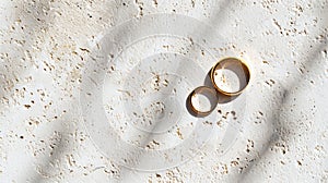 Wedding gold rings on light background with shadows. Aesthetic invitation concept. Generative AI