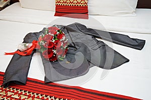 Wedding gray suit with red roses and gold ring