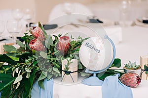 Wedding guest table decorated with bouquet and settings