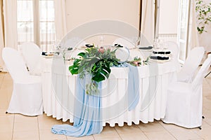 Wedding guest table decorated with bouquet and settings