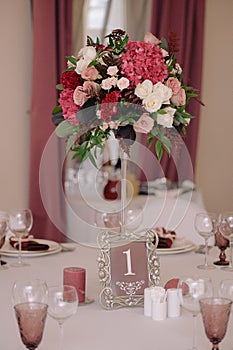 Wedding guest table decorated with bouquet and settings