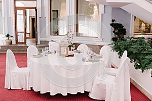 Wedding guest table, decorated with bouquet and settings