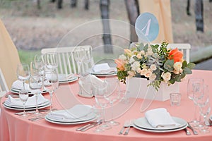 Wedding guest table decorated with bouquet and settings