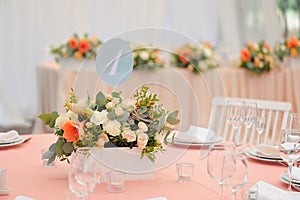 Wedding guest table decorated with bouquet and settings