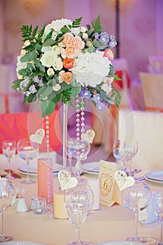 Wedding guest table decorated with bouquet and settings