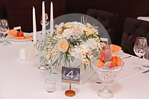 Wedding guest table decorated with bouquet and settings