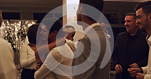 Wedding guests dancing with couple on the dance floor of the celebration reception or event. Group of people having fun