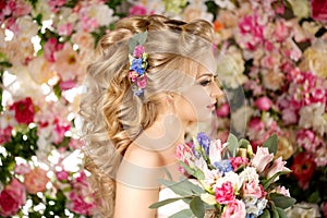 Wedding hairstyle a young girl. Bride. Woman with Flowers in her