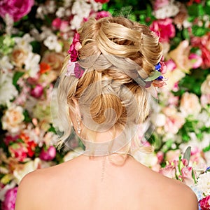 Wedding hairstyle a young girl. Bride. Woman with Flowers in her