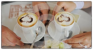 Wedding hands of a man and a woman of the bride and groom they hold in their hands Two cups of coffee on which there is