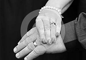 Wedding hands mature newlyweds couple isolated on black