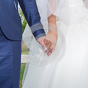 Hands of newly wedded in time of wedding ceremony photo