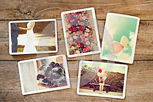 Wedding and honeymoon instant photo album on wood table.