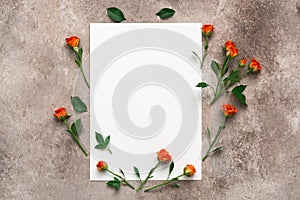 Wedding invitation, blank paper mock up and roses on beige grunge background. Greeting card. Modern minimal stationery still life