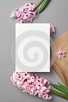 Wedding invitation card mockup with pink hyacinth flowers on grey background