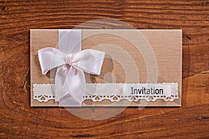 Wedding invitation envelope on old wooden board