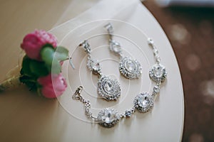 Wedding jewelry, white earrings and bracelet bride, wedding ceremony, the bride`s morning, preparing for the wedding