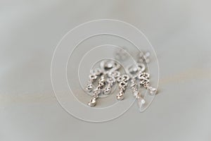 Wedding jewelry, white earrings and bracelet bride, wedding ceremony, the bride`s morning, preparing for the wedding