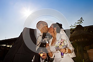 Wedding kiss with sparkling glass