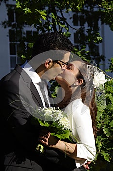 Wedding kiss of a young hispanic couple