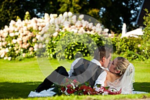 Wedding - kissing couple on meadow