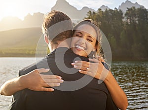 Wedding, lake and happy couple hugging in nature and water with passion, smile and romance. Marriage, excited bride and