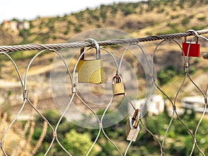 Wedding locks on a wire fence hung by newlyweds and lovers