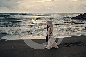 Wedding lovestory, just married couple near the ocean at sunset