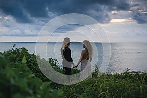 Wedding lovestory, just married couple near the ocean at sunset