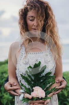 Wedding lovestory, just married couple near the ocean at sunset