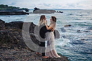 Wedding lovestory, just married couple near the ocean at sunset