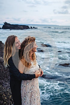 Wedding lovestory, just married couple near the ocean at sunset