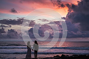 Wedding lovestory, just married couple near the ocean at sunset