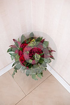 Wedding. Lush bridal Bouquet of red roses and a lot of greenery