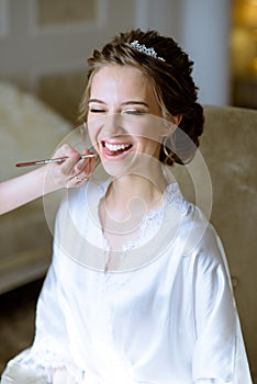 Wedding makeup artist making a make up for bride