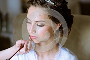 Wedding makeup artist making a make up for bride