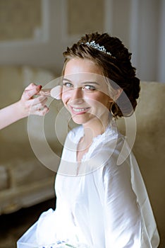 Wedding makeup artist making a make up for bride