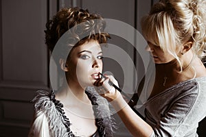 Wedding makeup artist making a make up for bride