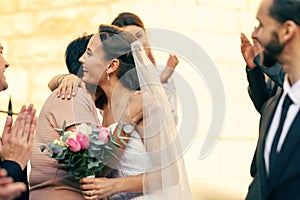 Wedding, marriage and bride hug family guests with a smile while leave church with groom after marrying, celebration and