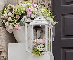 Wedding and marriage decoration. White boxes with flowers outside. Elegant bouquet. Arrangement and romance background.