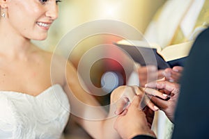 Wedding, marriage and putting ring on finger of bride in celebration of love, romance and commitment. Young couple