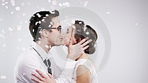 Wedding, married and kiss with a young couple kissing in studio on a gray background with mockup. Marriage, love and