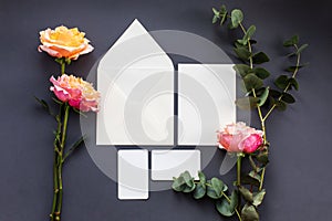 A wedding mock up composition. Wedding Invitation, envelope, paper cards with peony rose flower and sprig of eucalyptus