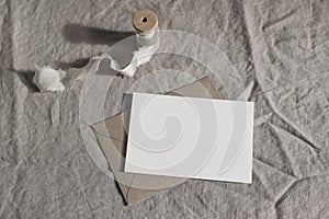 Wedding moody still life, table composition. Blank greeting card, invitation mockup scene with craft envelope and silk