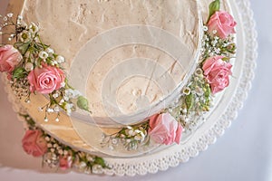 Wedding naked cake decorated with fresh flowers on top, product photography for patisserie