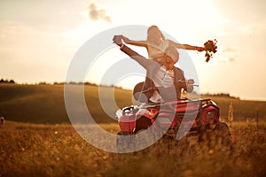 Wedding in nature.Happy  man and woman enjoying a quad atv vehicle at nature